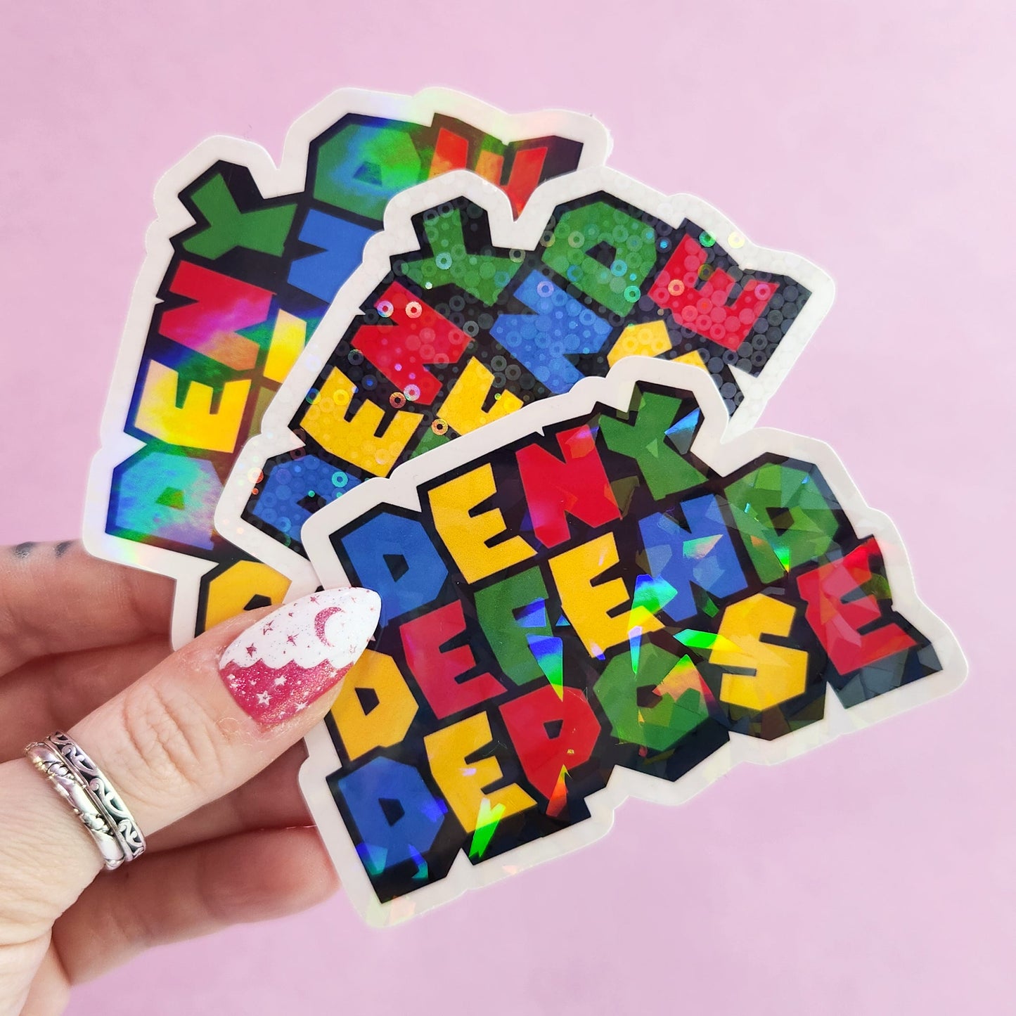 Deny Defend Depose Holographic Sticker, 3.3 x 2.2 in.