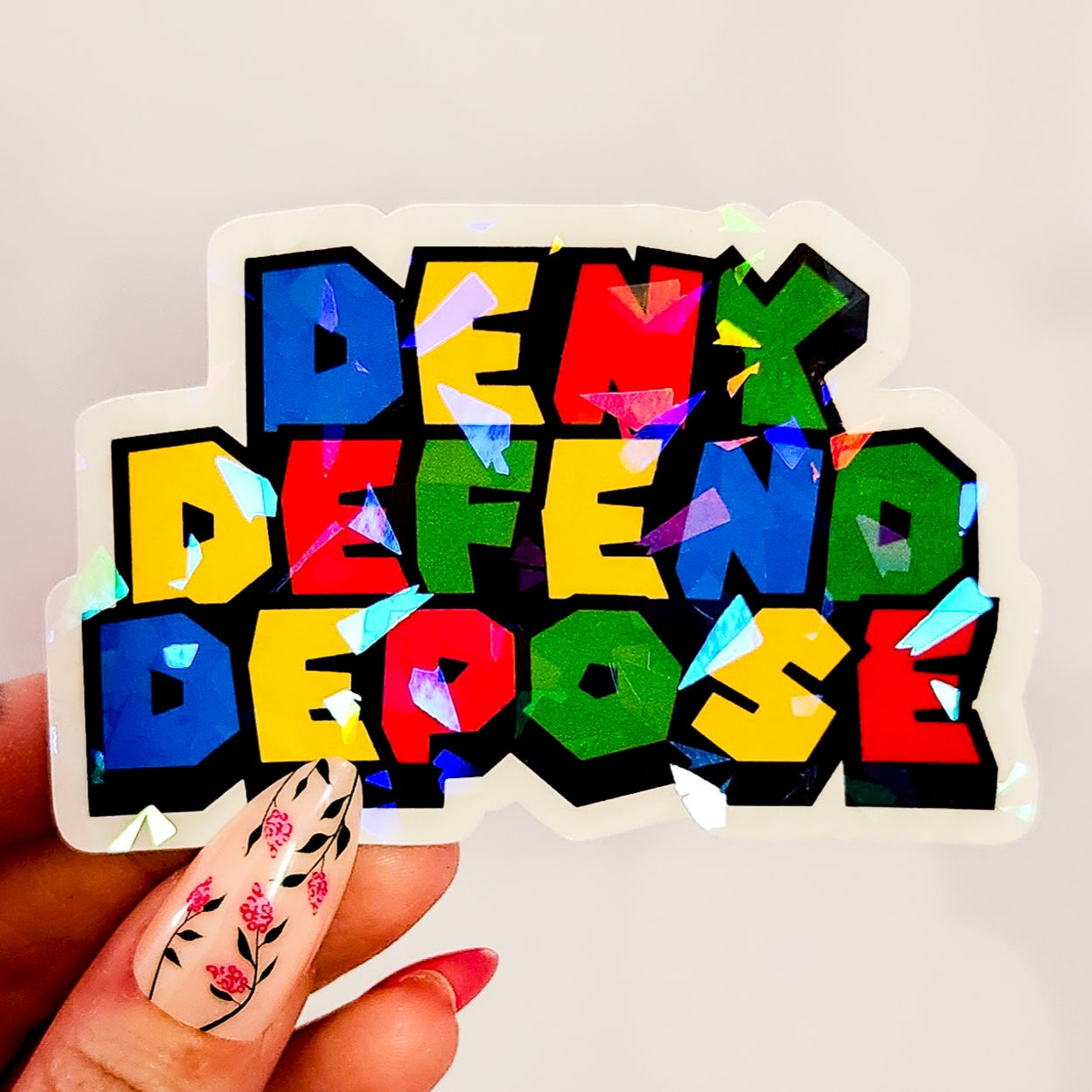 Deny Defend Depose Holographic Sticker, 3.3 x 2.2 in.